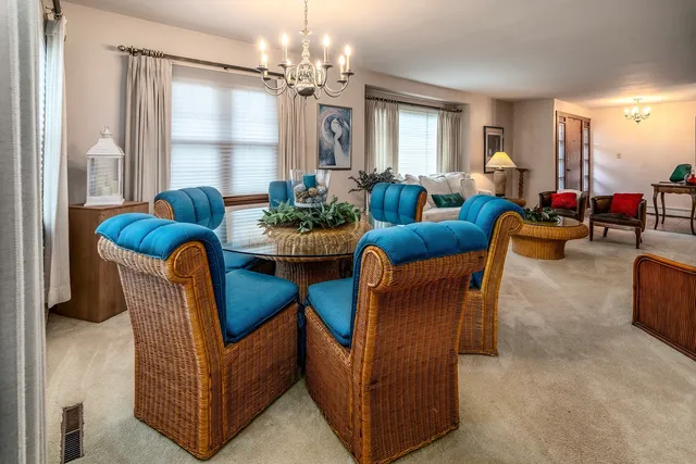 a dining room with furniture and a chandelier