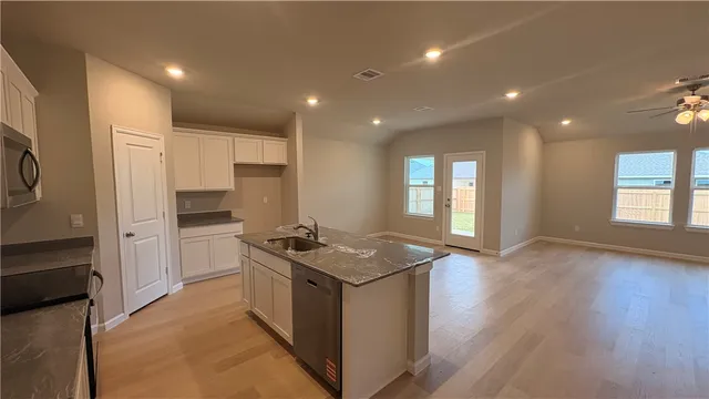 a kitchen with sink refrigerator and window