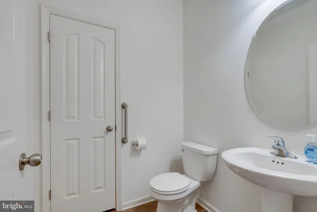a white toilet sitting next to a bathroom sink