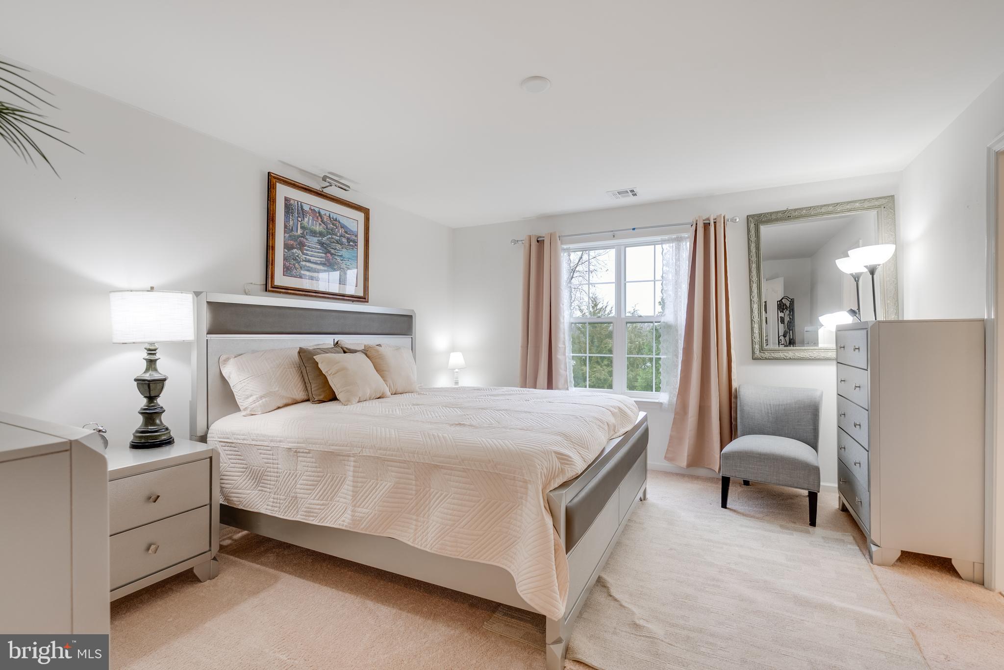 49 Creekside Way Burlington, NJ 08016 - Photo 13 of 25 a bedroom with a bed and a couch