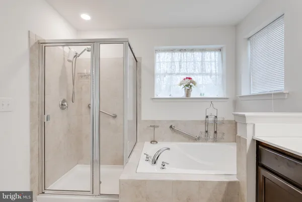 a bathroom with a tub and a sink