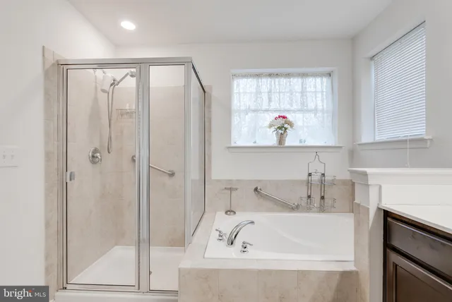 a bathroom with a tub and a sink