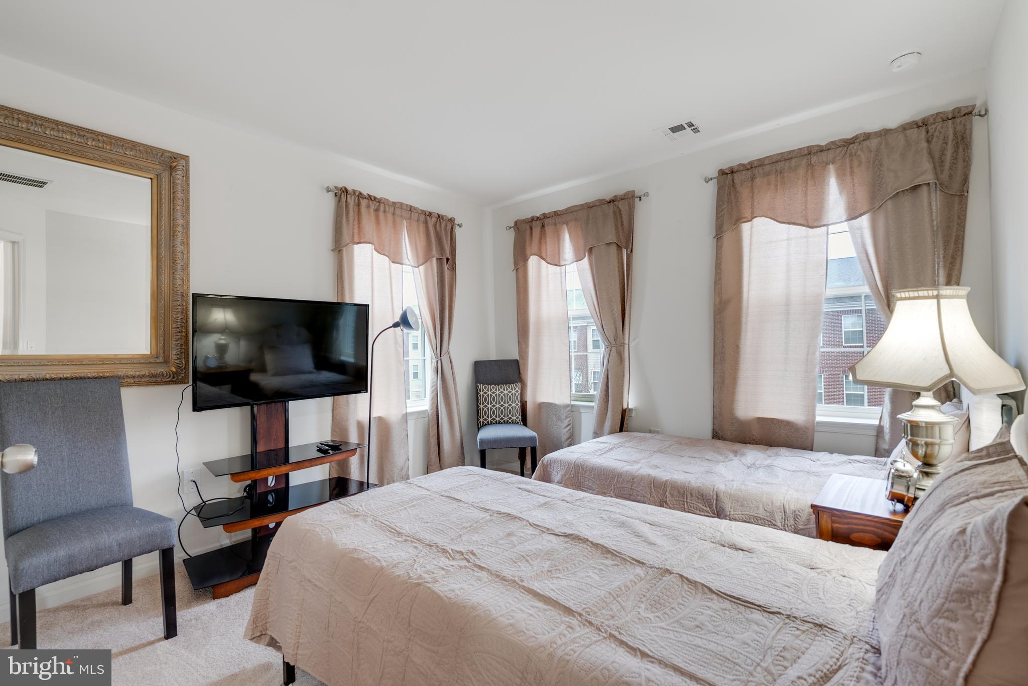 49 Creekside Way Burlington, NJ 08016 - Photo 17 of 25 a bedroom with a bed and a flat screen tv