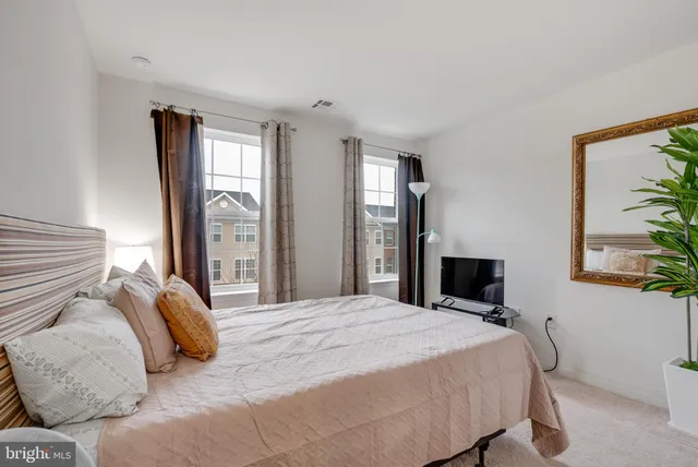 a bedroom with a large bed and a window