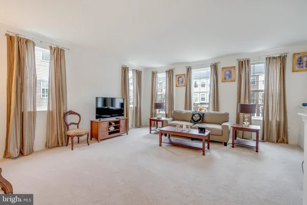 a living room with furniture and large windows