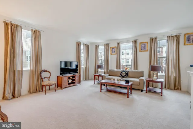 a living room with furniture and large windows
