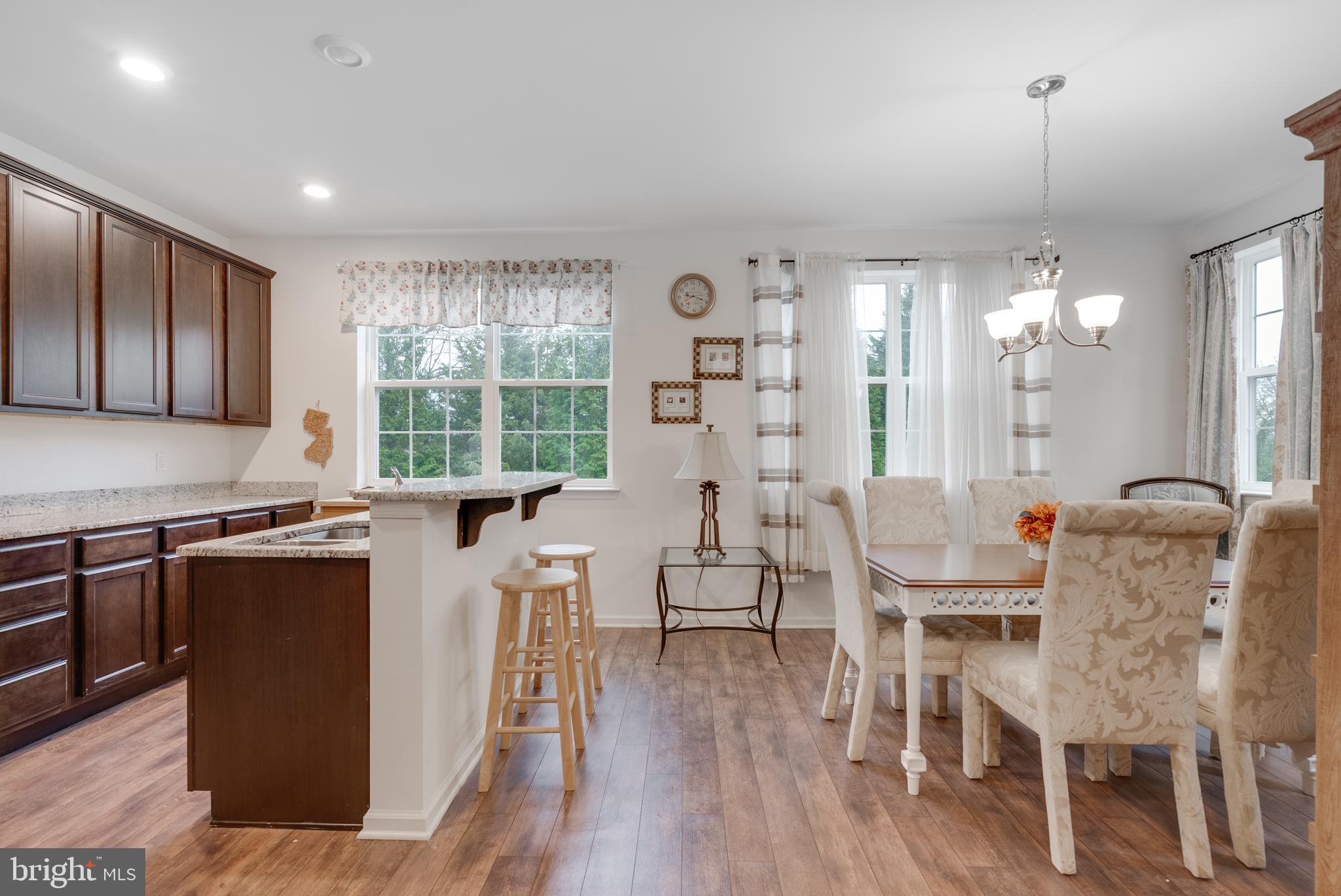 49 Creekside Way Burlington, NJ 08016 - Photo 7 of 25 a dining room with wooden floor and stainless steel appliances
