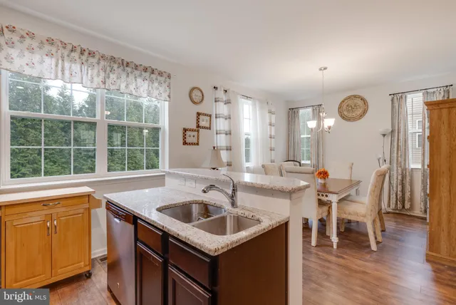 a kitchen with a sink a counter space and a dining table