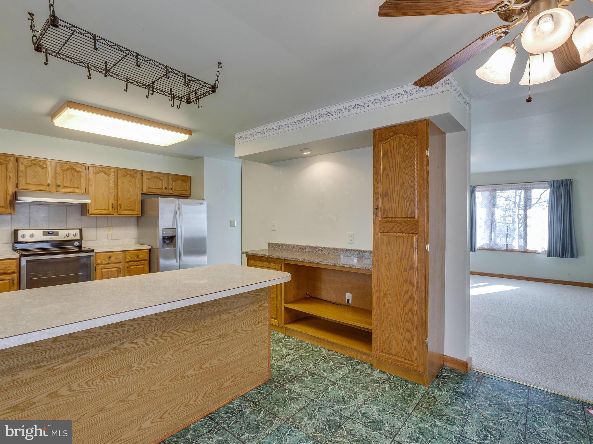 1897 Ridge Road Haymarket, VA 20169 - Photo 11 of 30 a large kitchen with kitchen island a stove a refrigerator and a sink