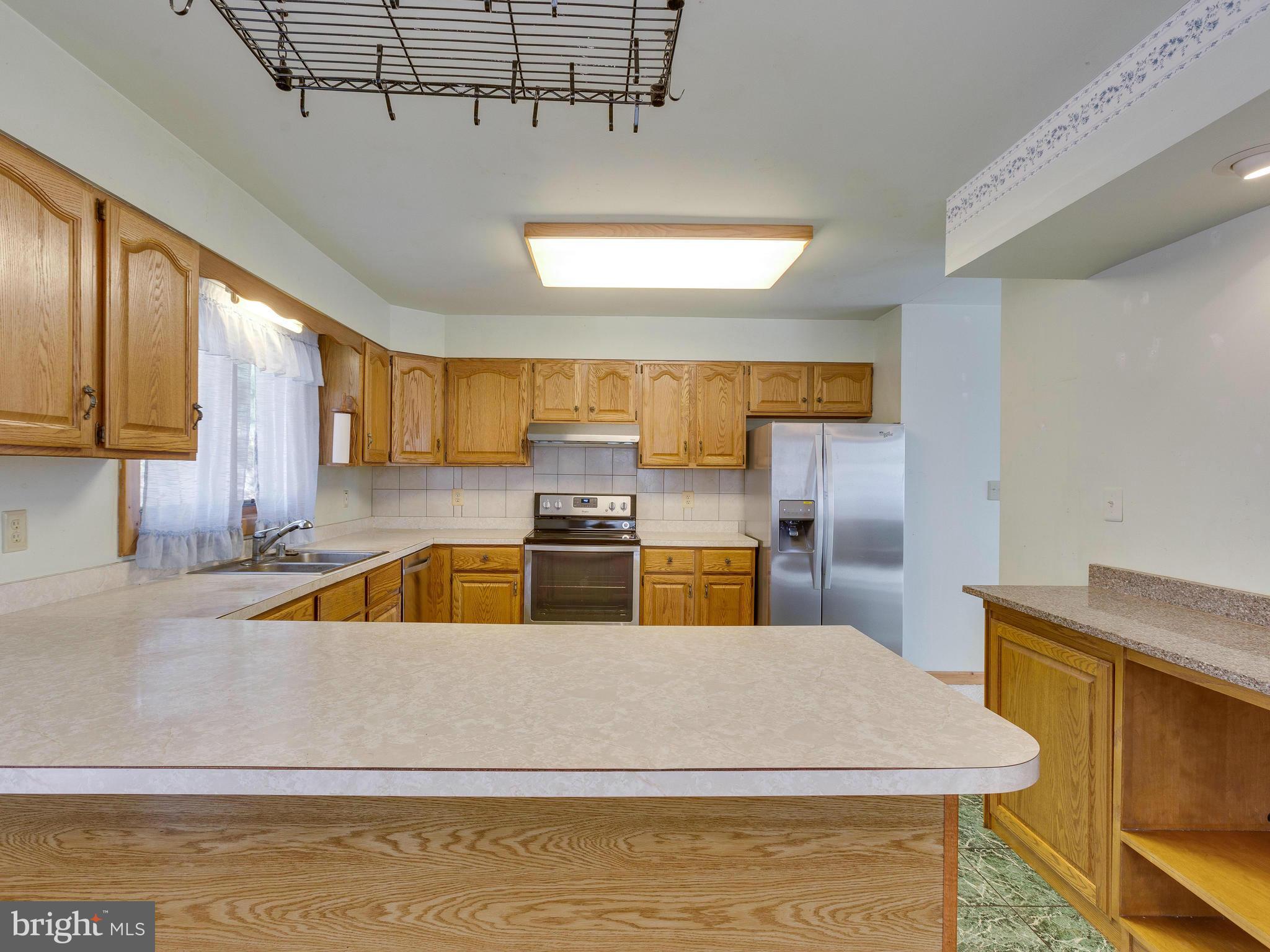 1897 Ridge Road Haymarket, VA 20169 - Photo 12 of 30 a kitchen with a stove a sink and a cabinets