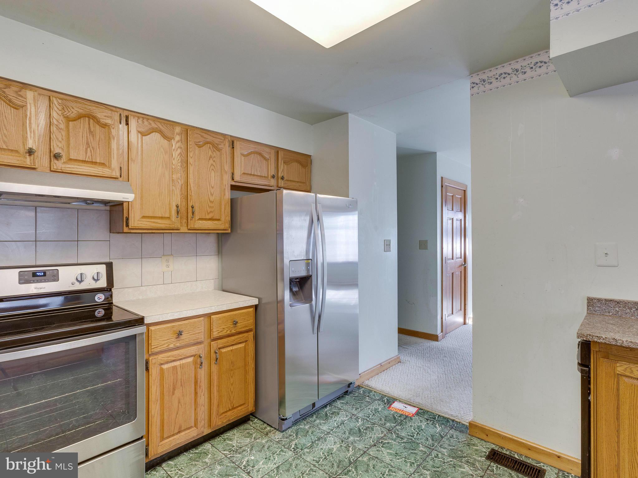 1897 Ridge Road Haymarket, VA 20169 - Photo 15 of 30 a kitchen with stainless steel appliances granite countertop a refrigerator sink and cabinets