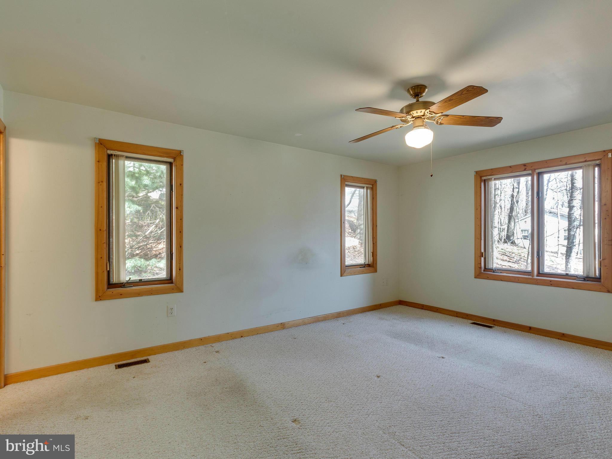 1897 Ridge Road Haymarket, VA 20169 - Photo 17 of 30 a view of an empty room with chandelier fan and fire place