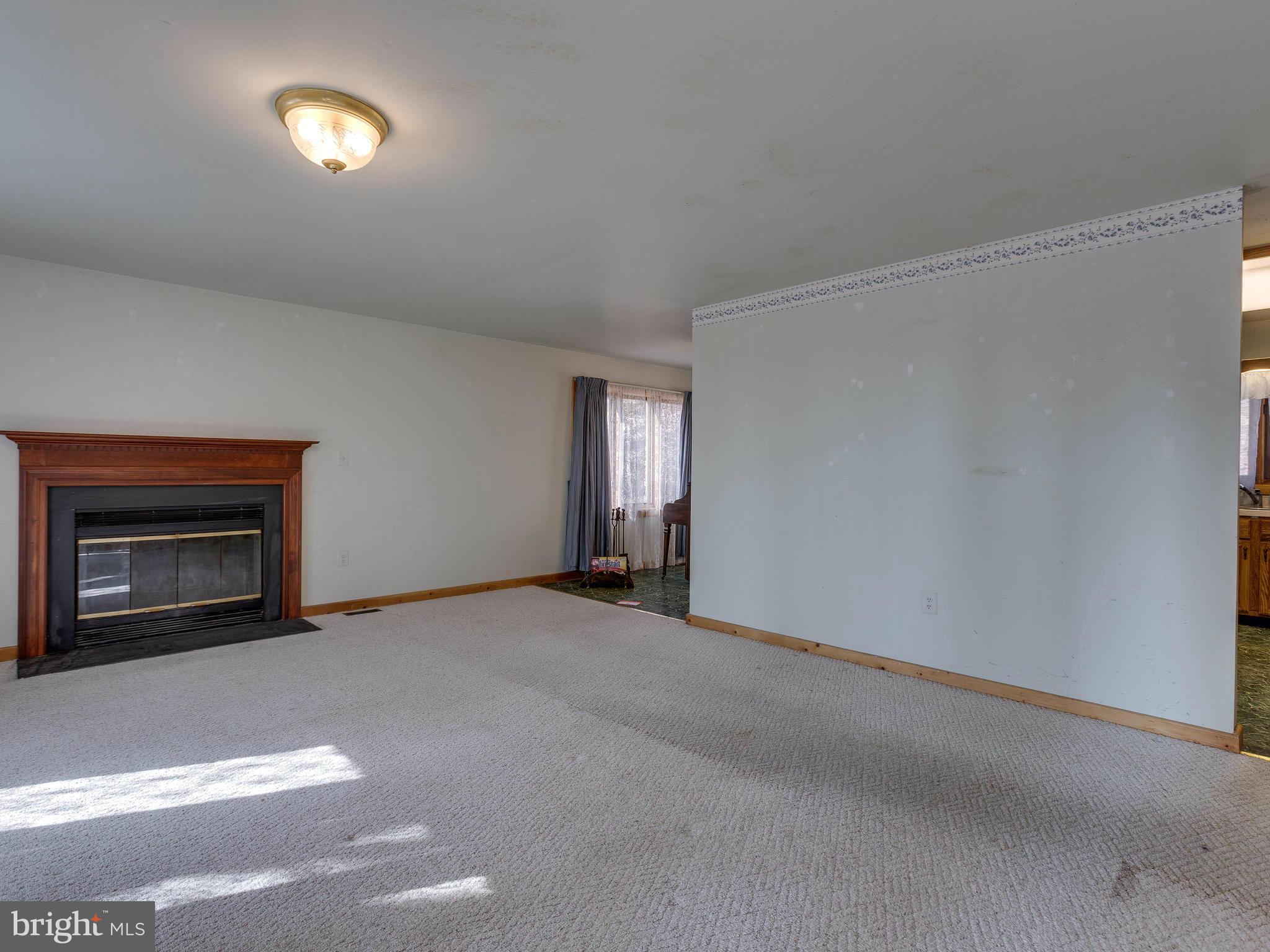 1897 Ridge Road Haymarket, VA 20169 - Photo 6 of 30 a view of an empty room with yellow lighting