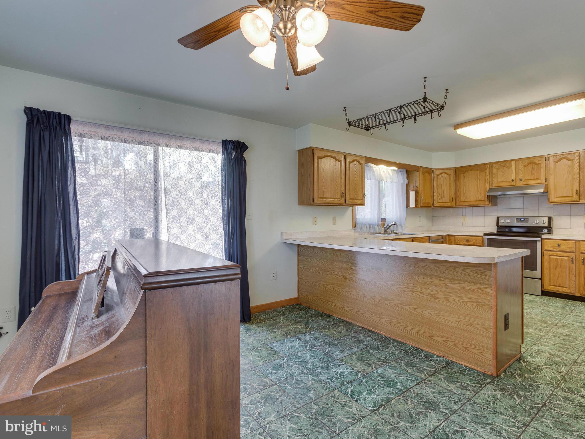 1897 Ridge Road Haymarket, VA 20169 - Photo 9 of 30 a kitchen with granite countertop a stove a sink and a refrigerator