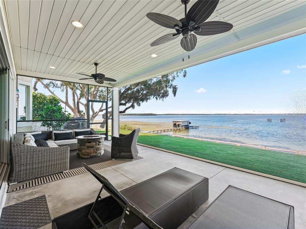 12943 Southeast Sunset Harbor Road Weirsdale, FL 32195 - Photo 74 of 87 a view of a patio with a table and chairs