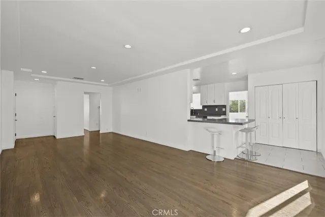 a view of kitchen with kitchen island microwave and cabinets