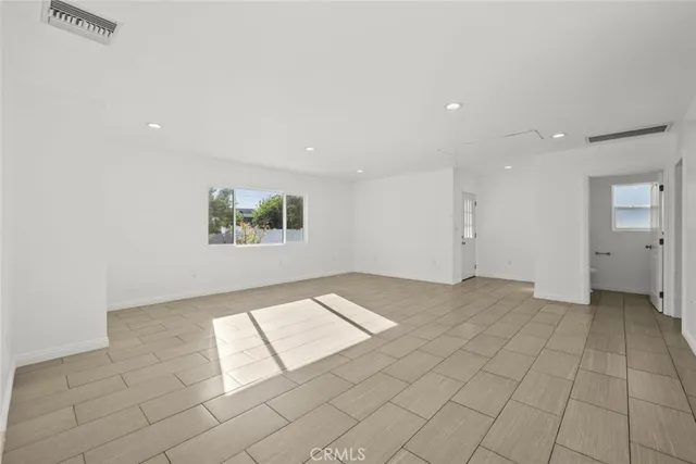 a view of an empty room and a window