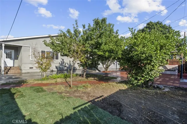 a view of a couches in patio with a small yard
