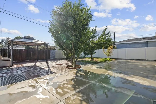 a view of a house with a yard and tree s