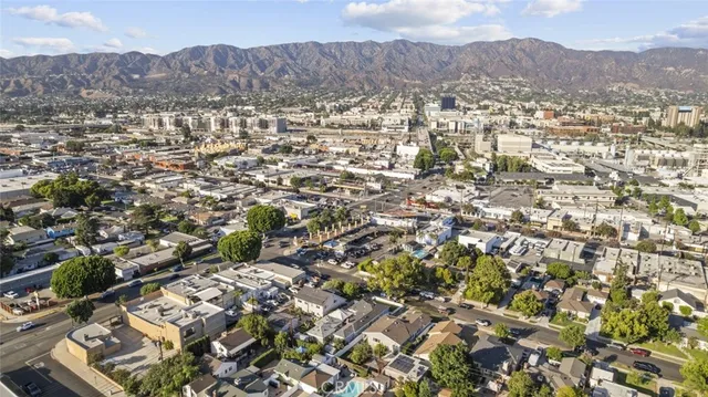 an aerial view of residential houses with outdoor space and trees