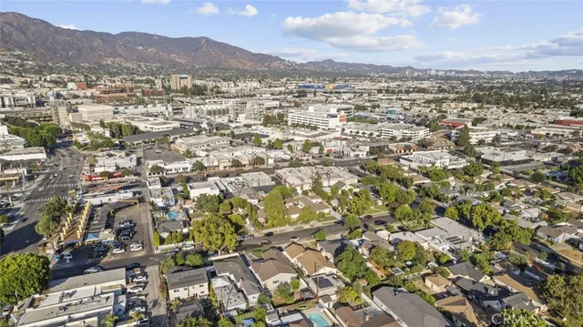 an aerial view of residential houses with outdoor space and trees