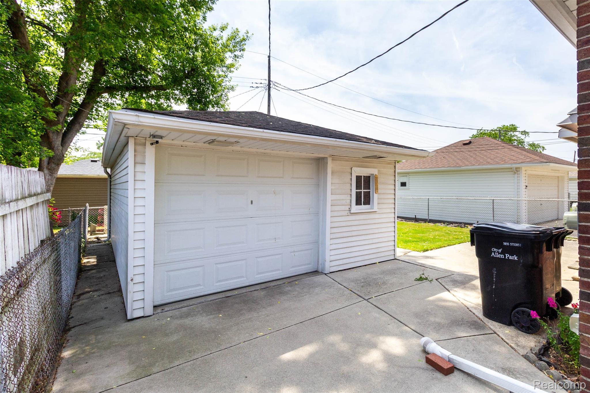14869 Champaign Road Allen Park, MI 48101 - Photo 31 of 34 Detached garage with white horizontal siding and a single garage door