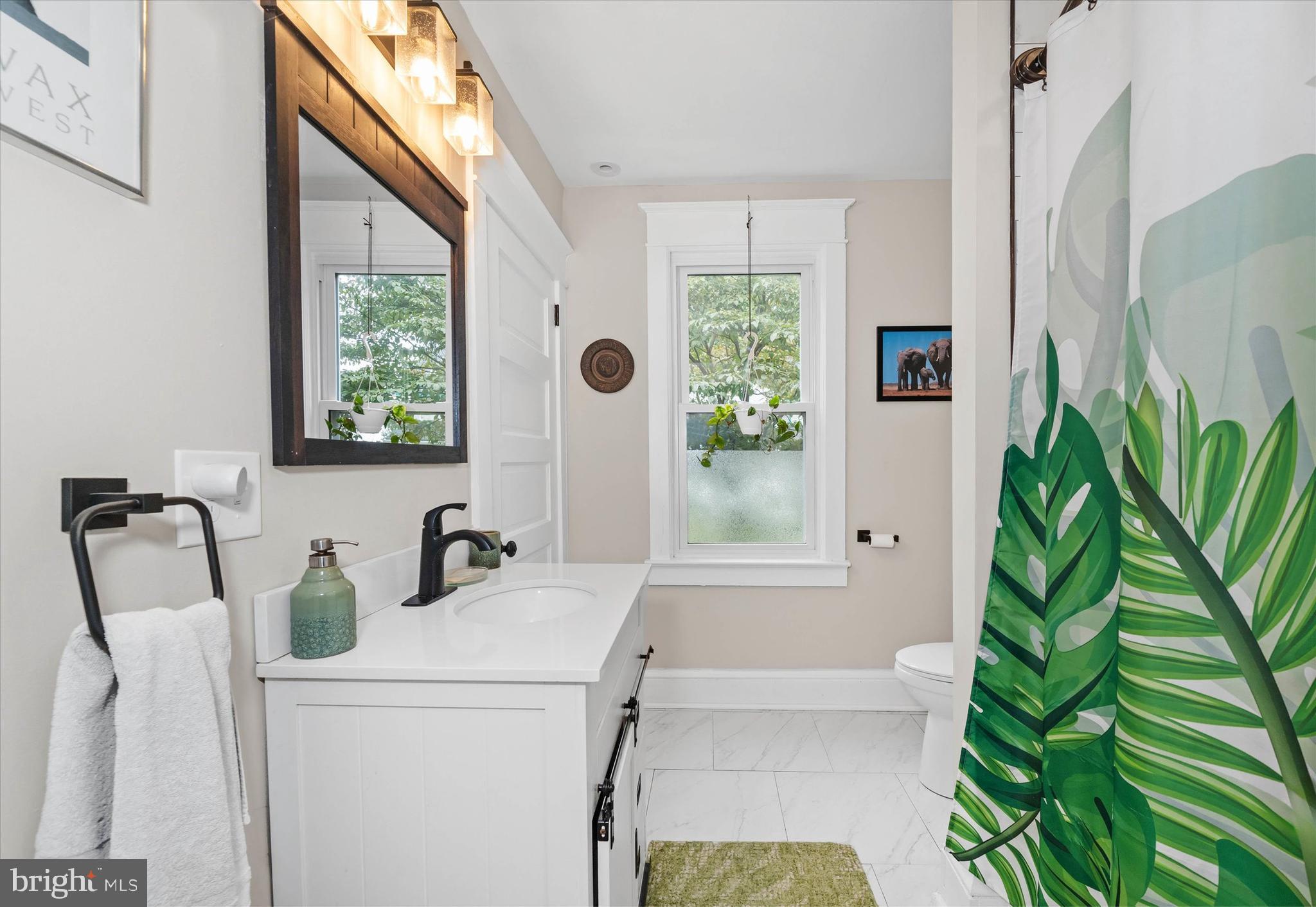 3024 Foulk Road Garnet Valley, PA 19060 - Photo 13 of 43 a bathroom with a sink a mirror a potted plant and a window