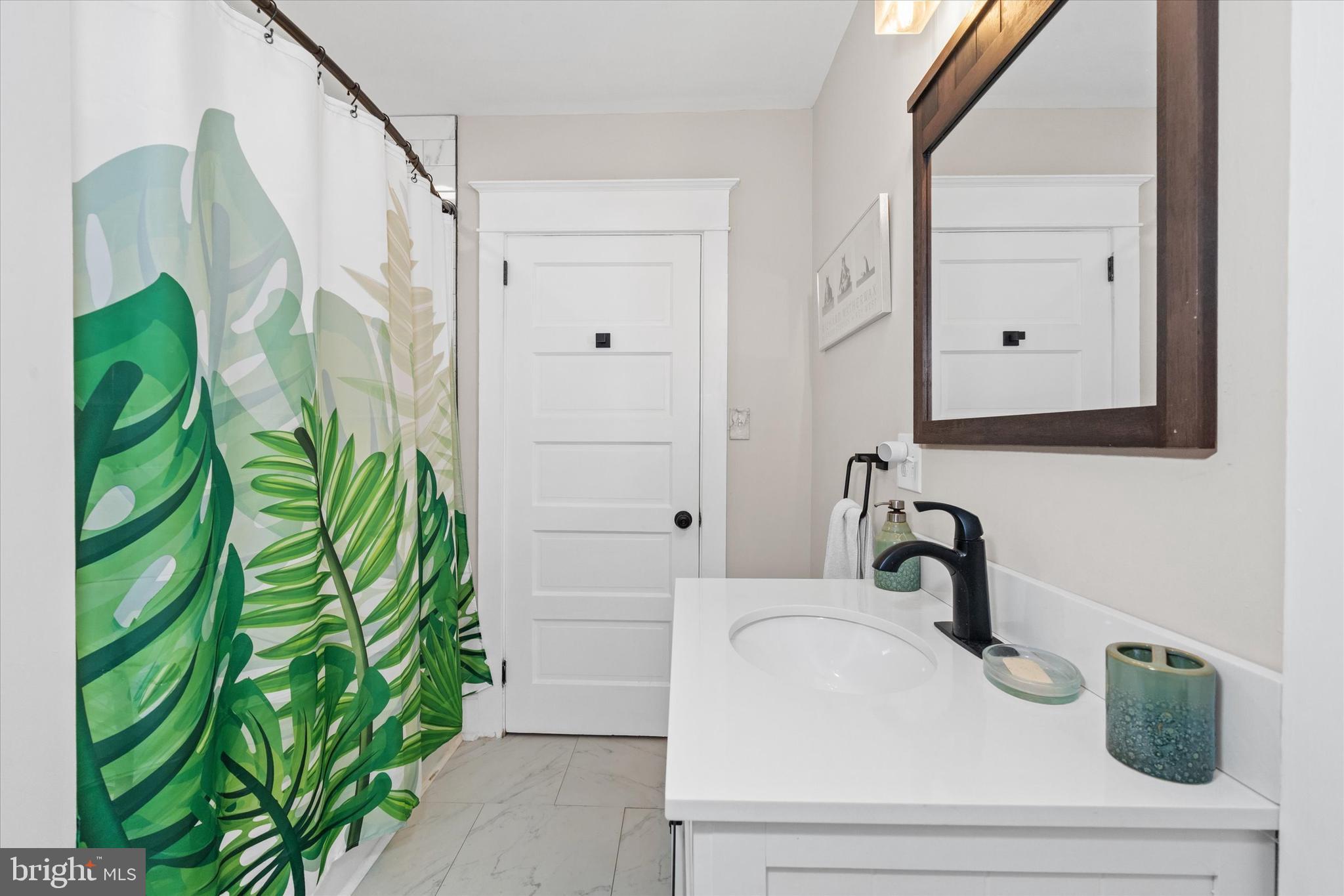3024 Foulk Road Garnet Valley, PA 19060 - Photo 14 of 43 a bathroom with a sink a mirror and vanity