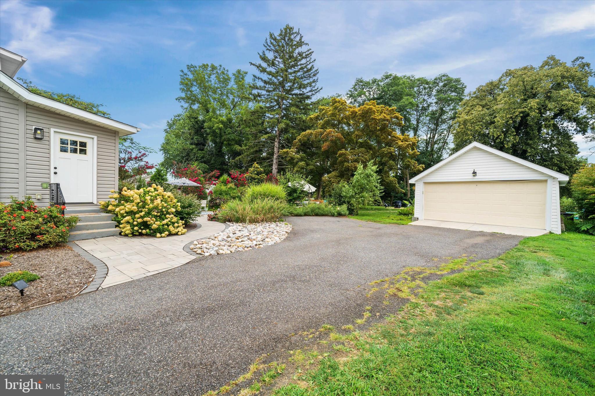 3024 Foulk Road Garnet Valley, PA 19060 - Photo 33 of 43 a front view of a house with a yard and garage