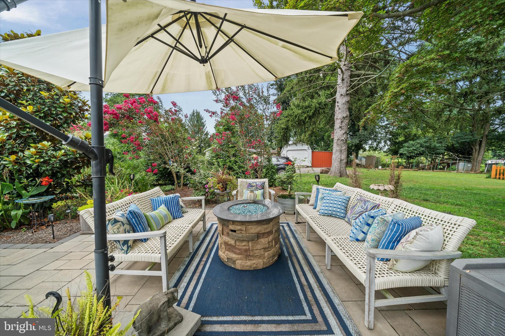 3024 Foulk Road Garnet Valley, PA 19060 - Photo 38 of 43 a view of a patio with couches table and chairs under an umbrella