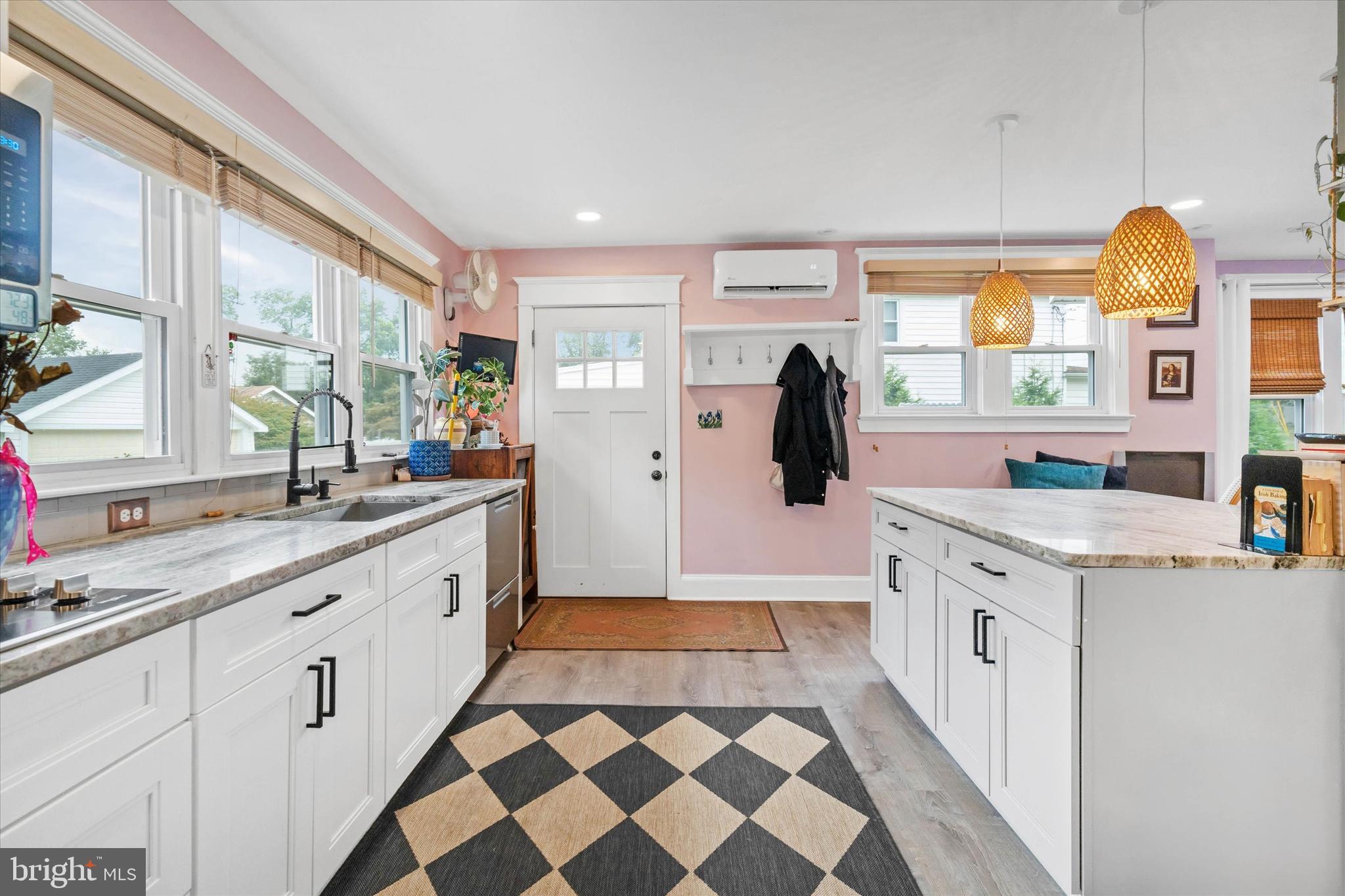 3024 Foulk Road Garnet Valley, PA 19060 - Photo 6 of 43 a large white kitchen with a sink a large window and stainless steel appliances