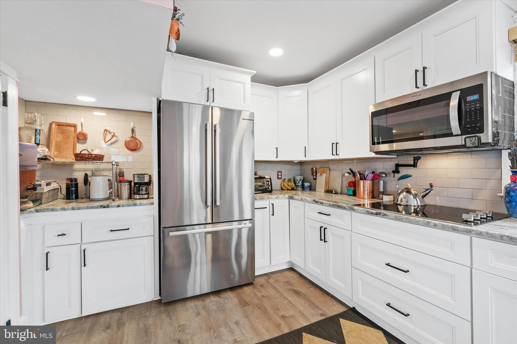 3024 Foulk Road Garnet Valley, PA 19060 - Photo 7 of 43 a kitchen with granite countertop white cabinets and stainless steel appliances