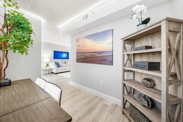 a kitchen with stainless steel appliances a white stove top oven and a wooden floor