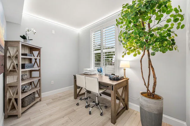 a view of a workspace with furniture and a potted plant