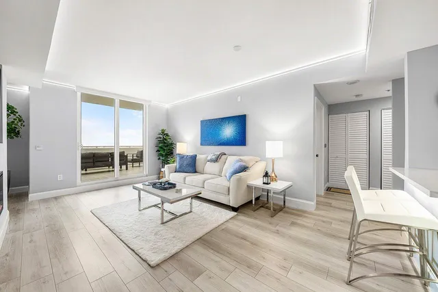 a living room with furniture and a large window