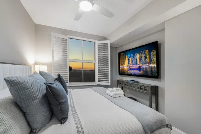 a bedroom with furniture and a flat screen tv