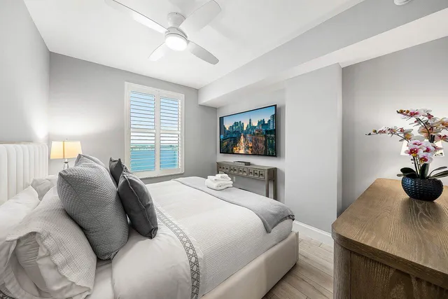 a bedroom with a bed and a flat screen tv