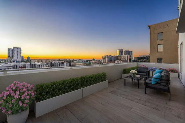 a terrace with outdoor seating and city view