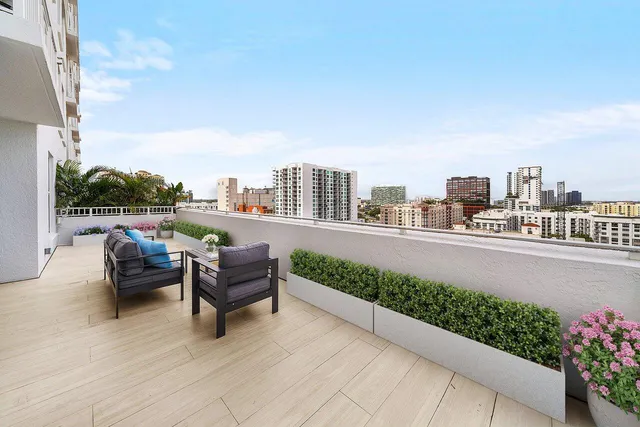 a balcony with furniture and city view