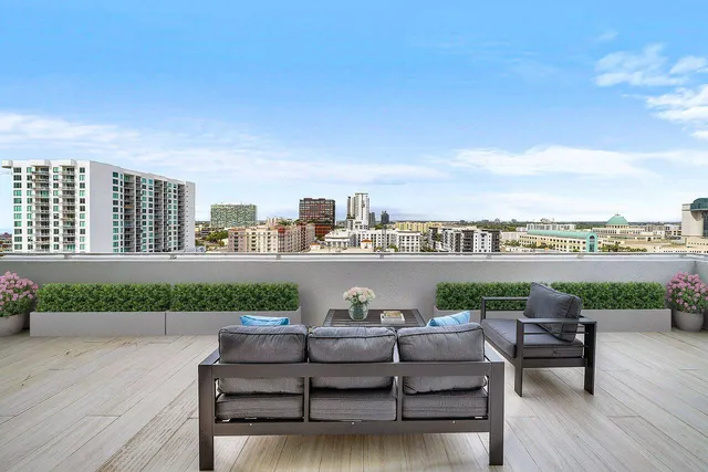 a view of a terrace with couches and city view
