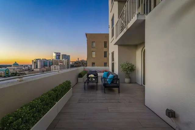 a view of a balcony with two chairs and a table