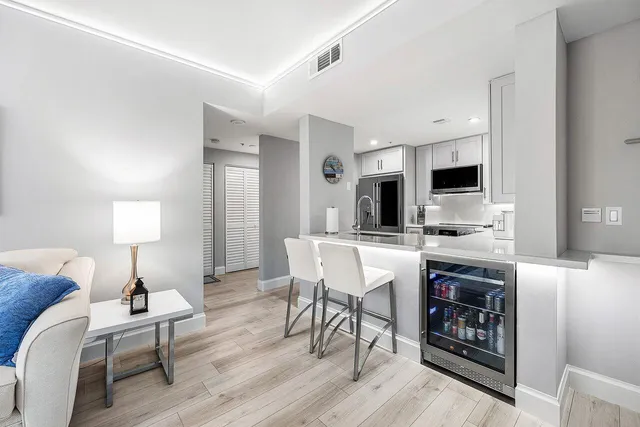 a kitchen with a table chairs refrigerator and cabinets