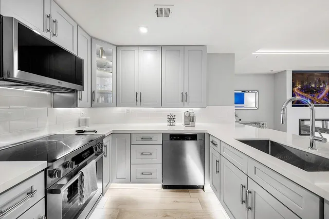 a kitchen with a sink stove and microwave