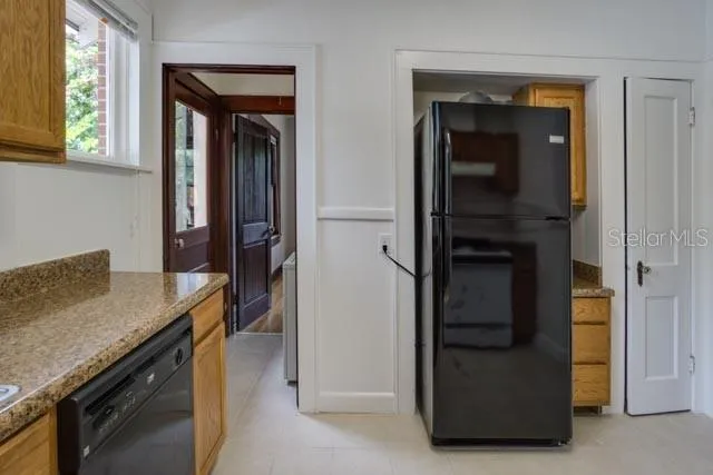 a kitchen with a refrigerator and a stove