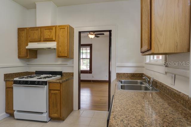 113 Northwest 11th Street Gainesville, FL 32601 - Photo 4 of 12 a kitchen with a stove and a sink