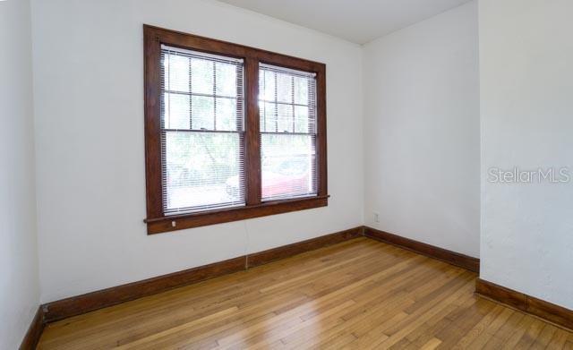 113 Northwest 11th Street Gainesville, FL 32601 - Photo 8 of 12 a view of a room with wooden floor and a window