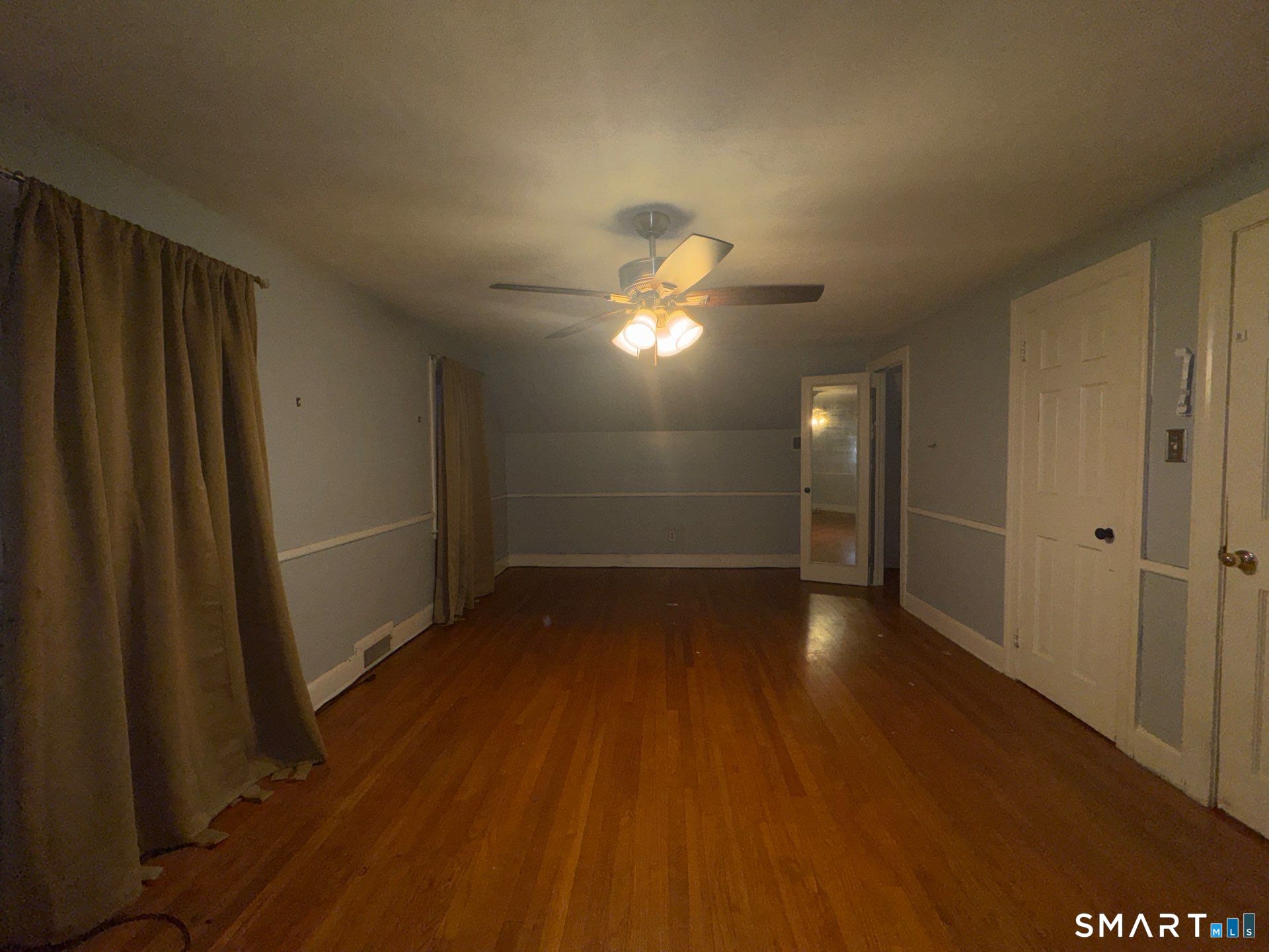 81 Lancaster Road Bristol, CT 06010 - Photo 11 of 30 an empty room with wooden floor and windows