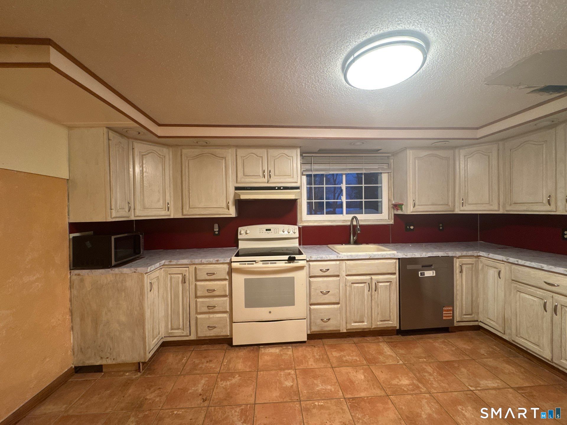 81 Lancaster Road Bristol, CT 06010 - Photo 12 of 30 a kitchen with a stove top oven sink and cabinets