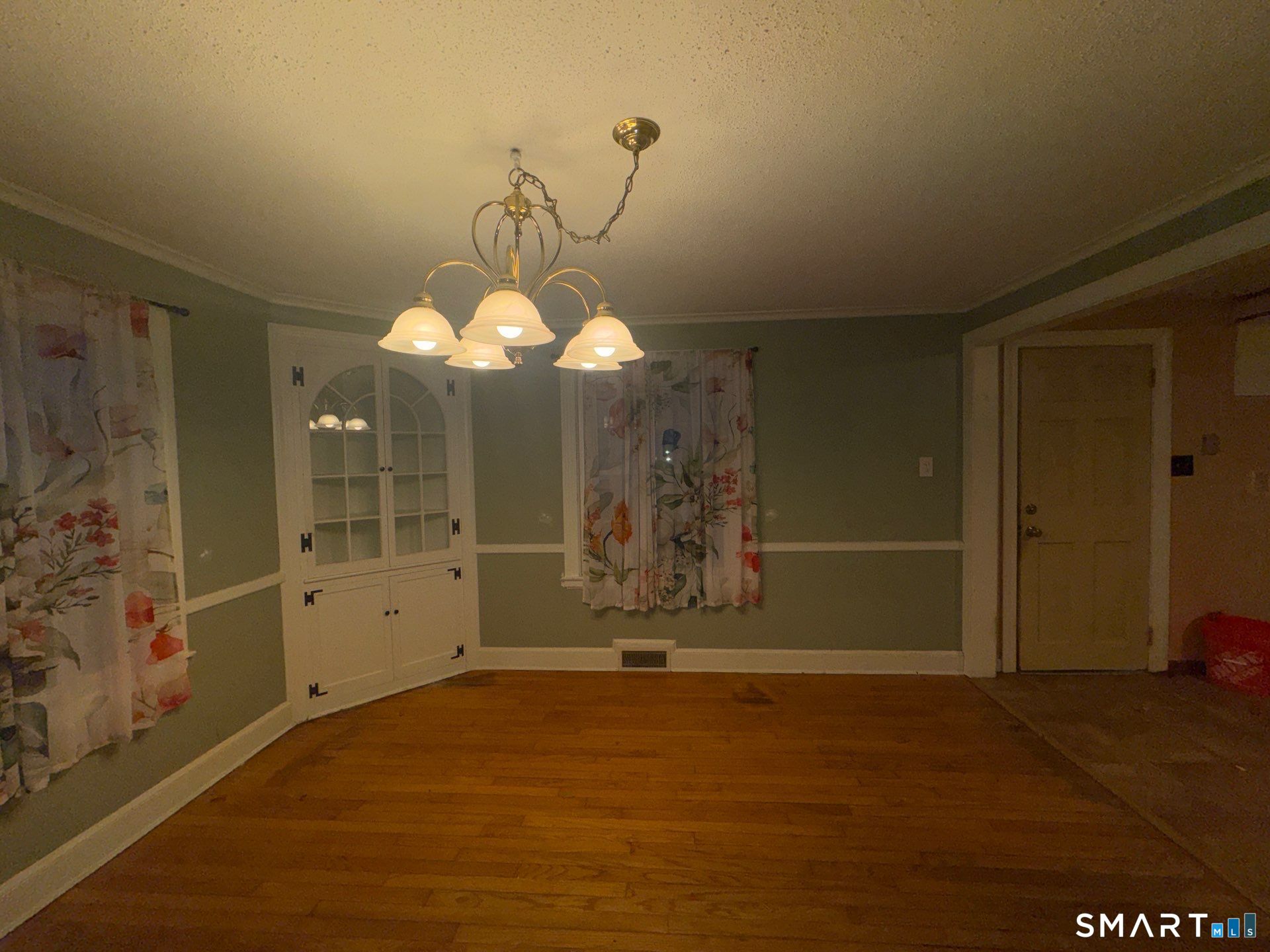 81 Lancaster Road Bristol, CT 06010 - Photo 5 of 30 a view of a livingroom with a chandelier fan and kitchen view