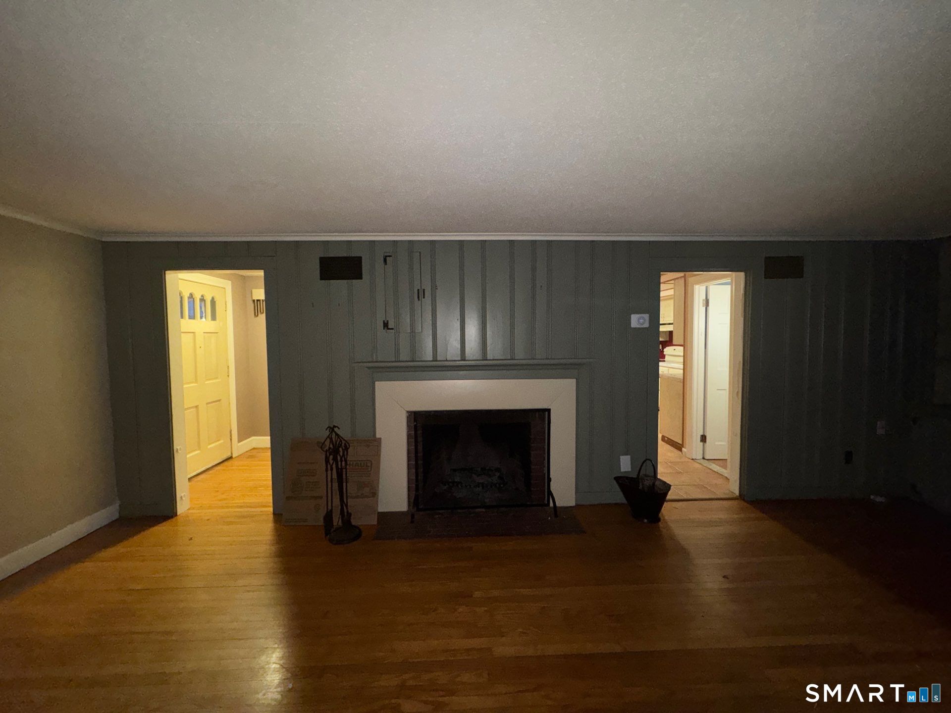 81 Lancaster Road Bristol, CT 06010 - Photo 7 of 30 a view of an empty room with wooden floor and a fireplace